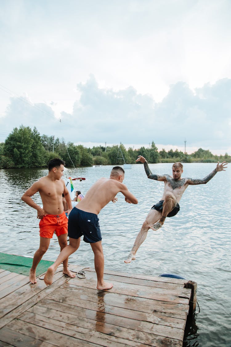 Young Men Jumping Into Lake 