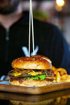 Close-up of a delicious cheeseburger and fries served on a wooden tray at a Cyprus restaurant.
