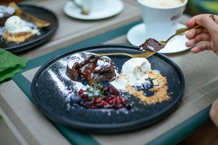 Woman Eating Dessert With Teaspoon