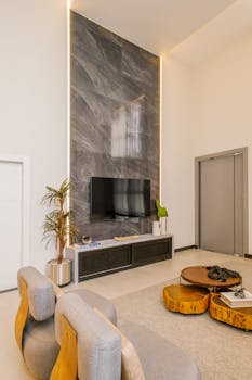 Contemporary living room featuring a sleek marble accent wall and modern furnishings.