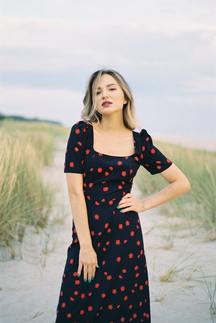 Woman In Long Black Dress Posing In Field