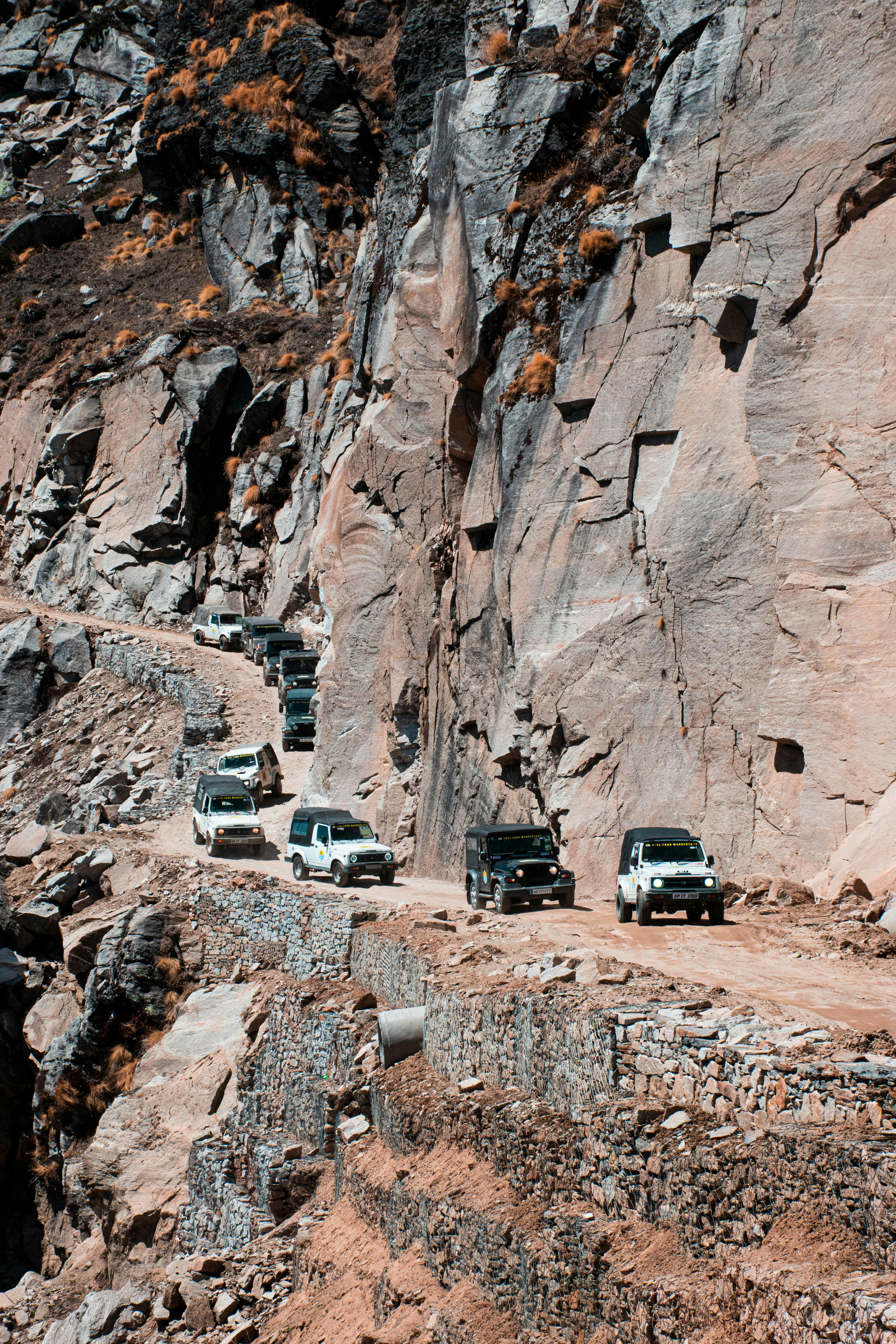 Cars on Road beside Rock Formation · Free Stock Photo