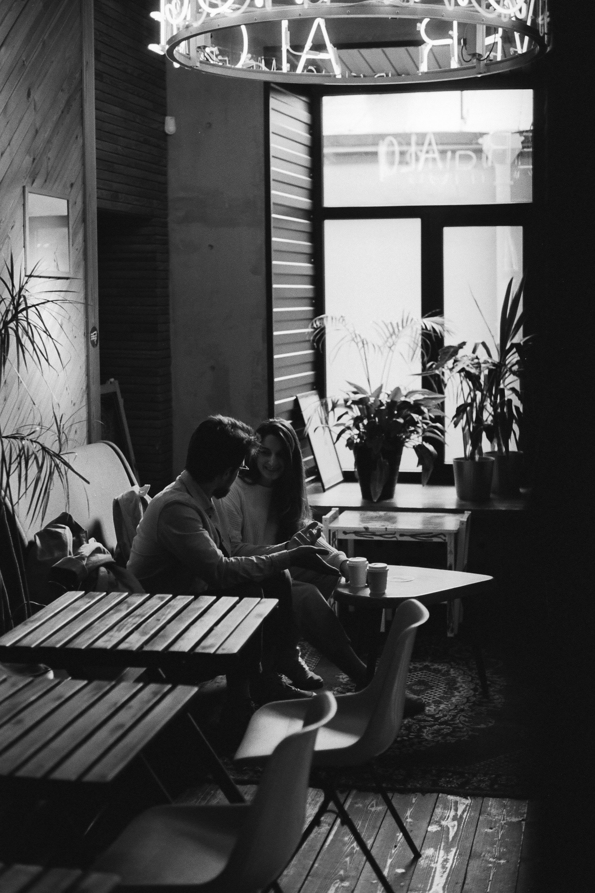 Black and White Photo of Two People in a Cafeteria · Free Stock Photo