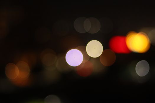 A vibrant display of bokeh lights against a dark background, perfect for creative projects.
