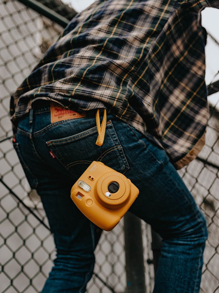 Rear View Of Yellow Camera On Jeans