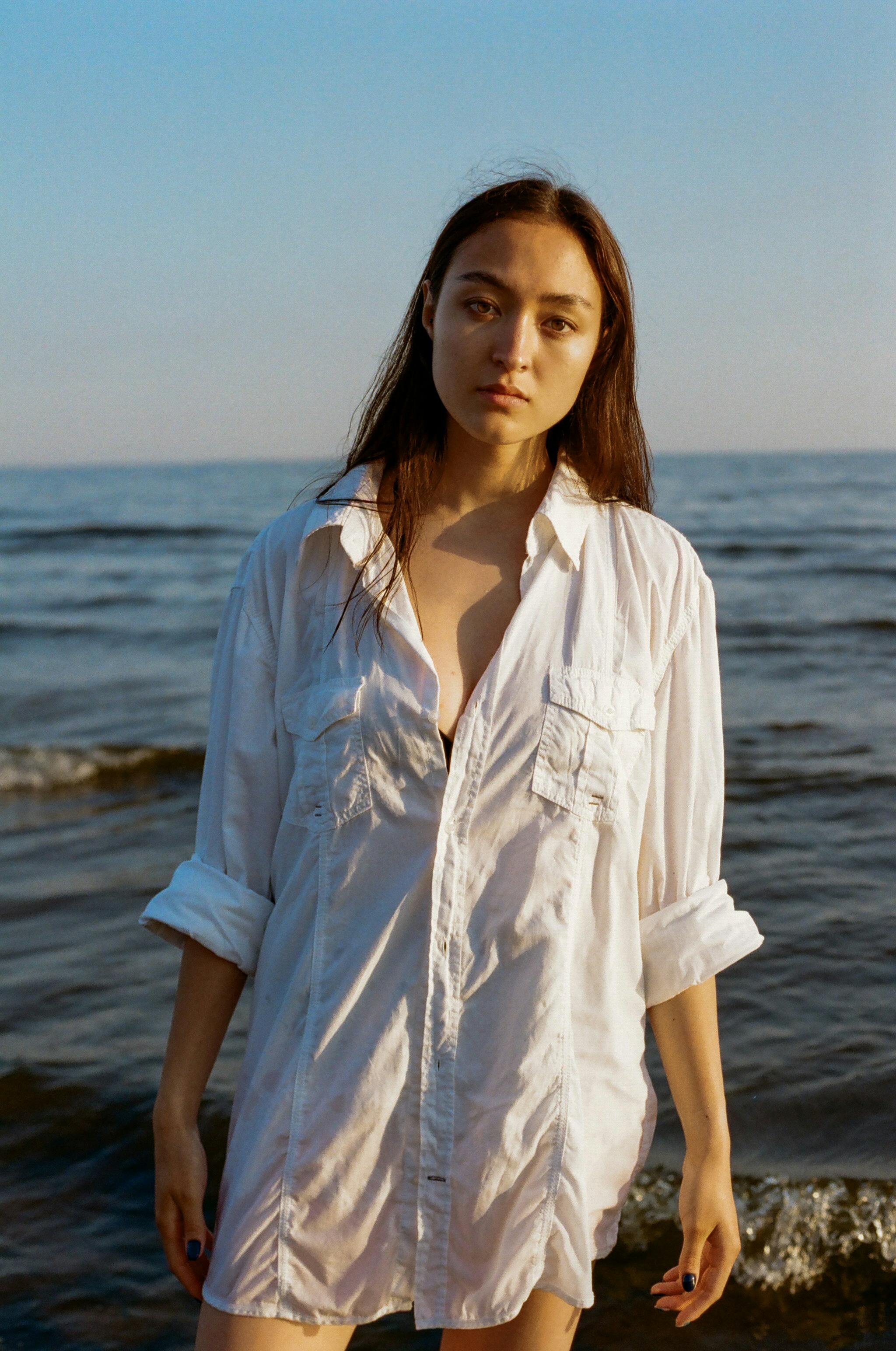 Woman in Oversized White Shirt at Sea Free Stock Photo