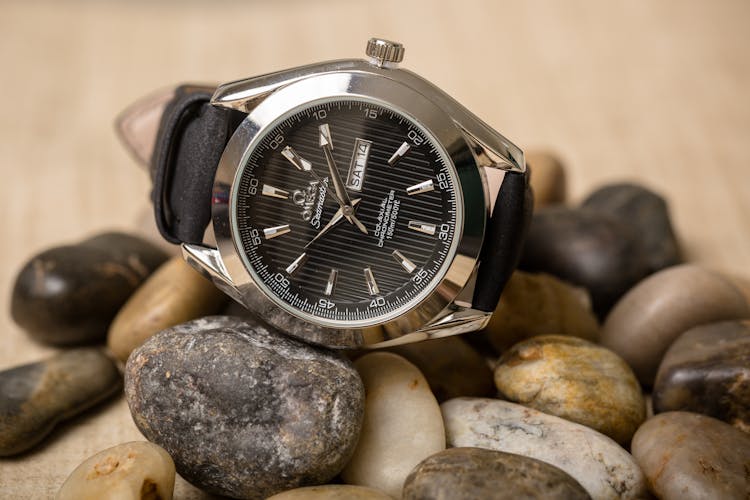 Close-up Photo Of An Omega Wristwatch On Pebbles