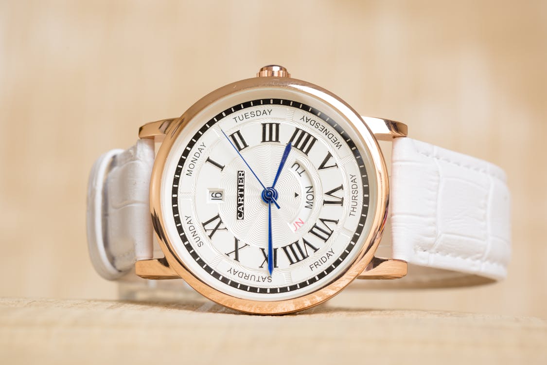 Free Close-Up Shot of a White and Gold Cartier Wrist Watch Stock Photo