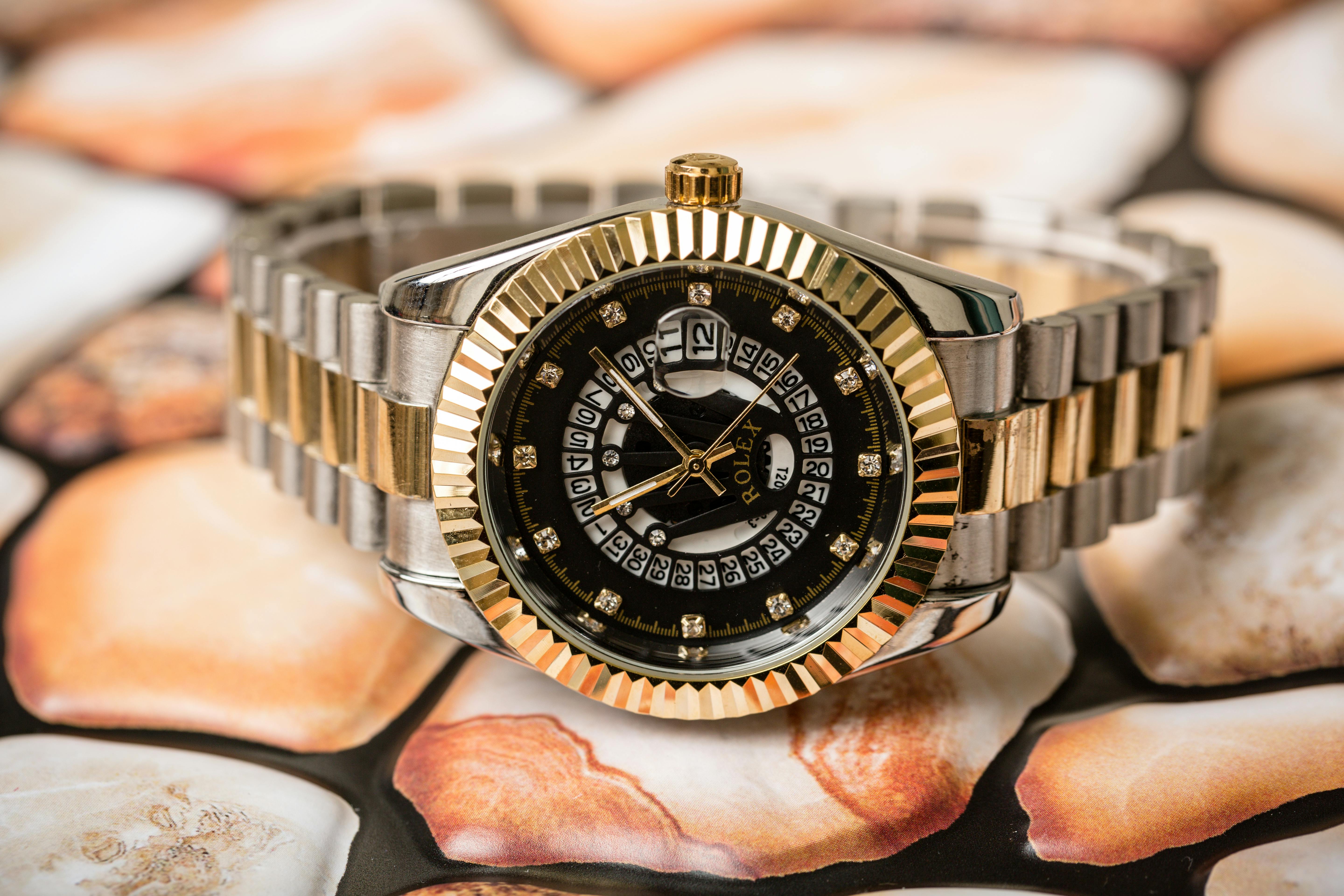 silver and gold rolex wristwatch