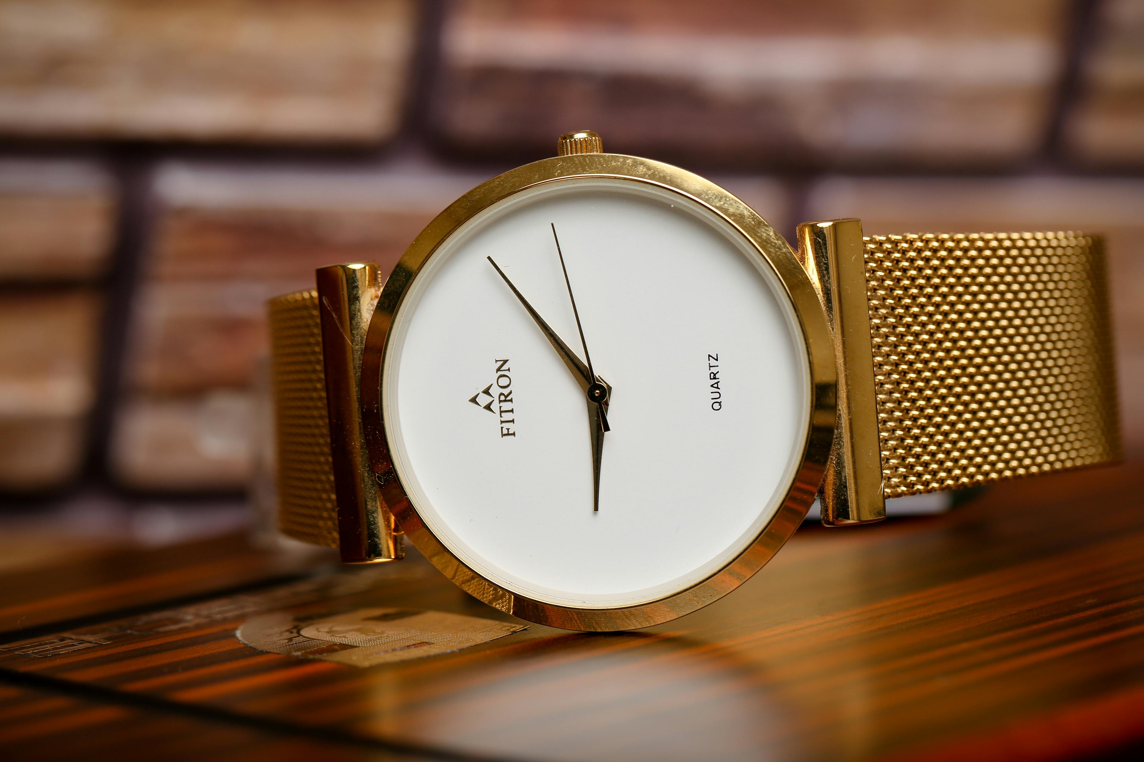 Gold Round Analog Watch on Wooden Surface · Free Stock Photo