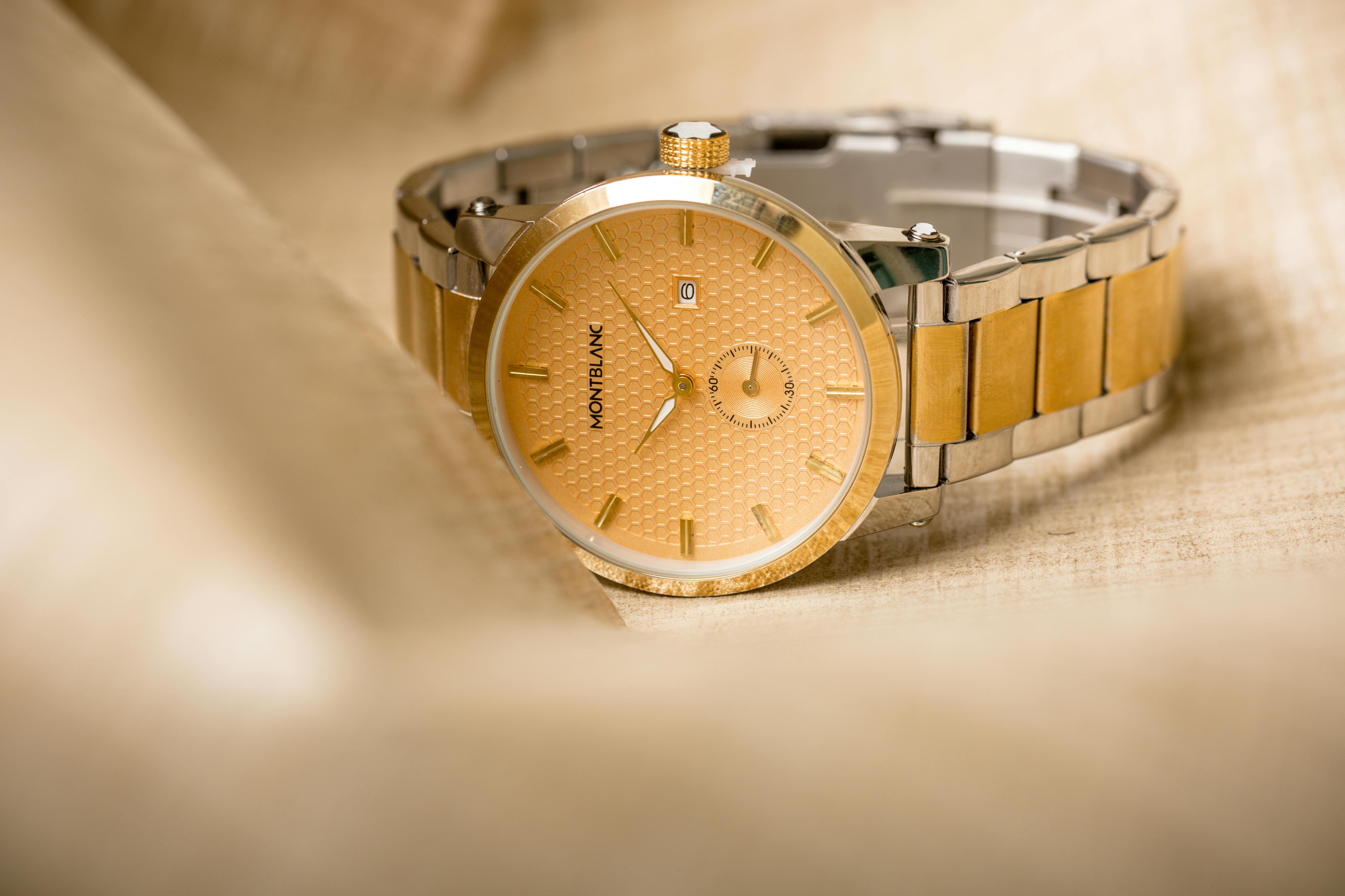 close up of a silver and gold wrist watch