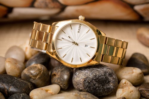 Free Gold Watch on Top of Stones Stock Photo