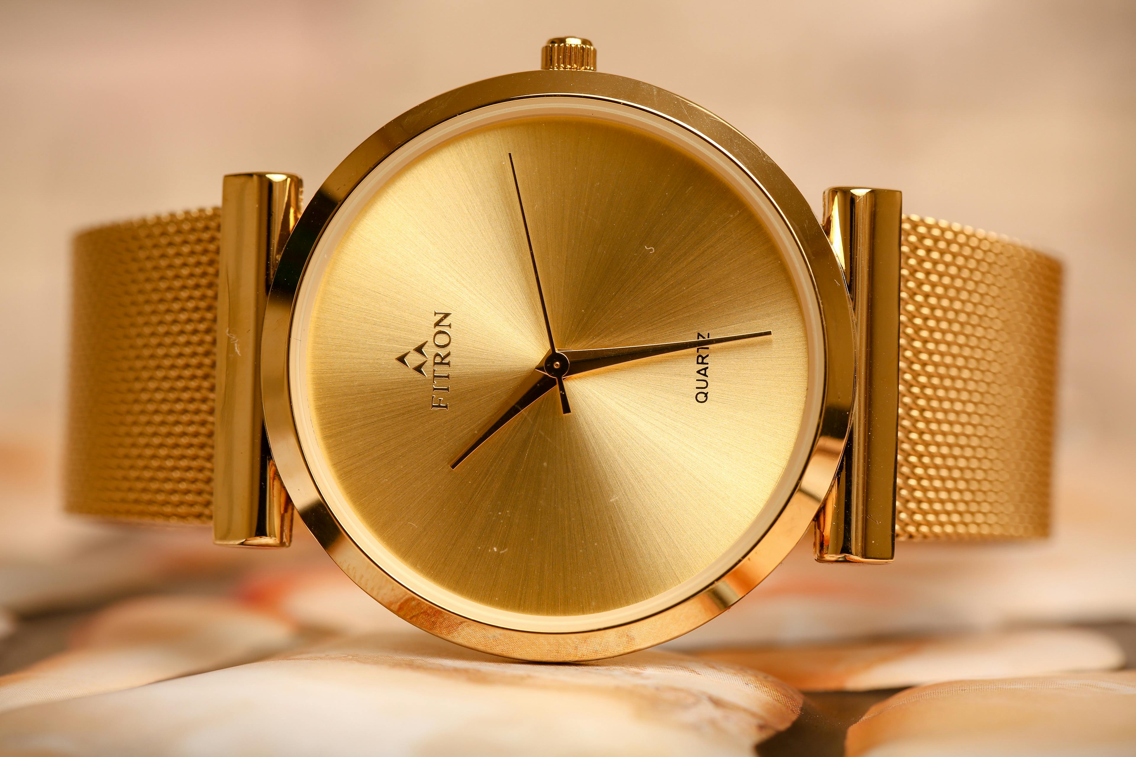 fitron round analog watch with gold strap