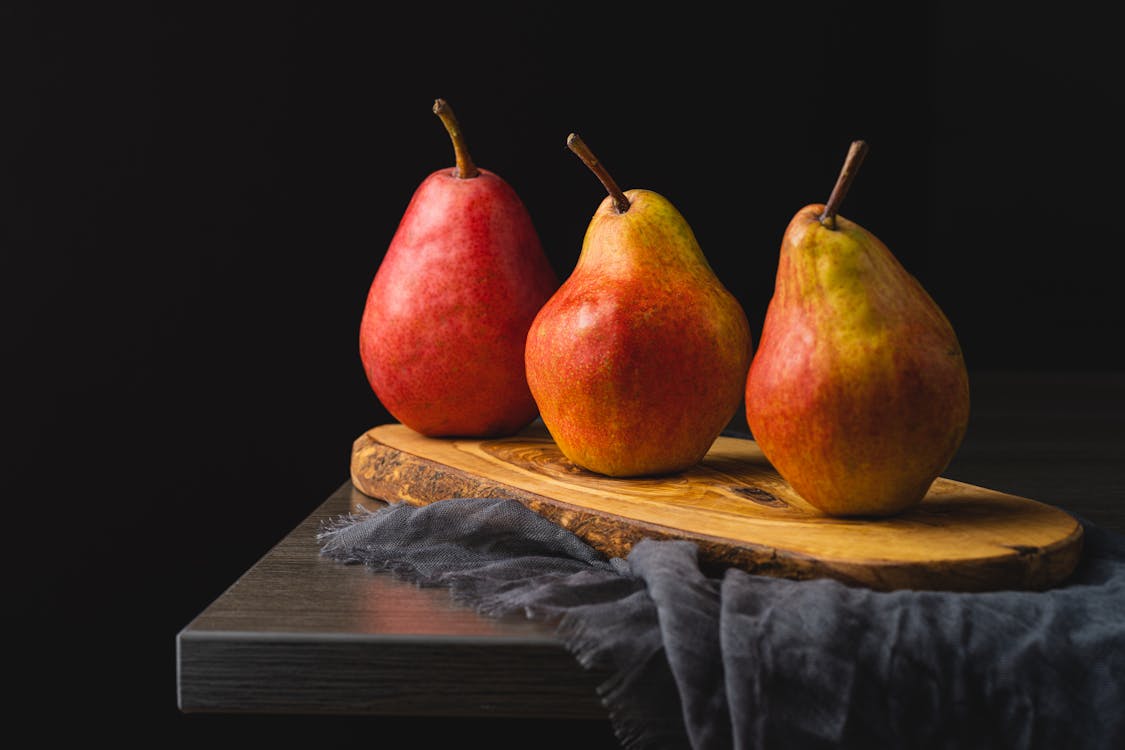 Still Life with Three Pears on Black Background · Free Stock Photo