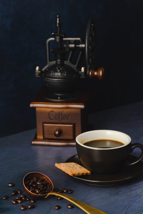 Still Life with Coffee And Coffee Grinder on Black Background