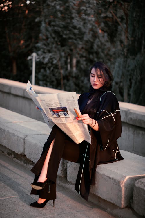 Free Photo of a Woman Reading a Newspaper Stock Photo