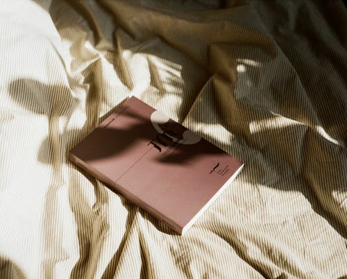 Free Book on Bed in Sunlight Stock Photo