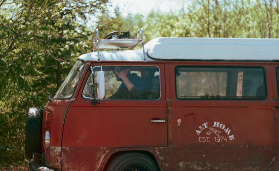 Red and White Volkswagen T-2 Van Parked on the Street