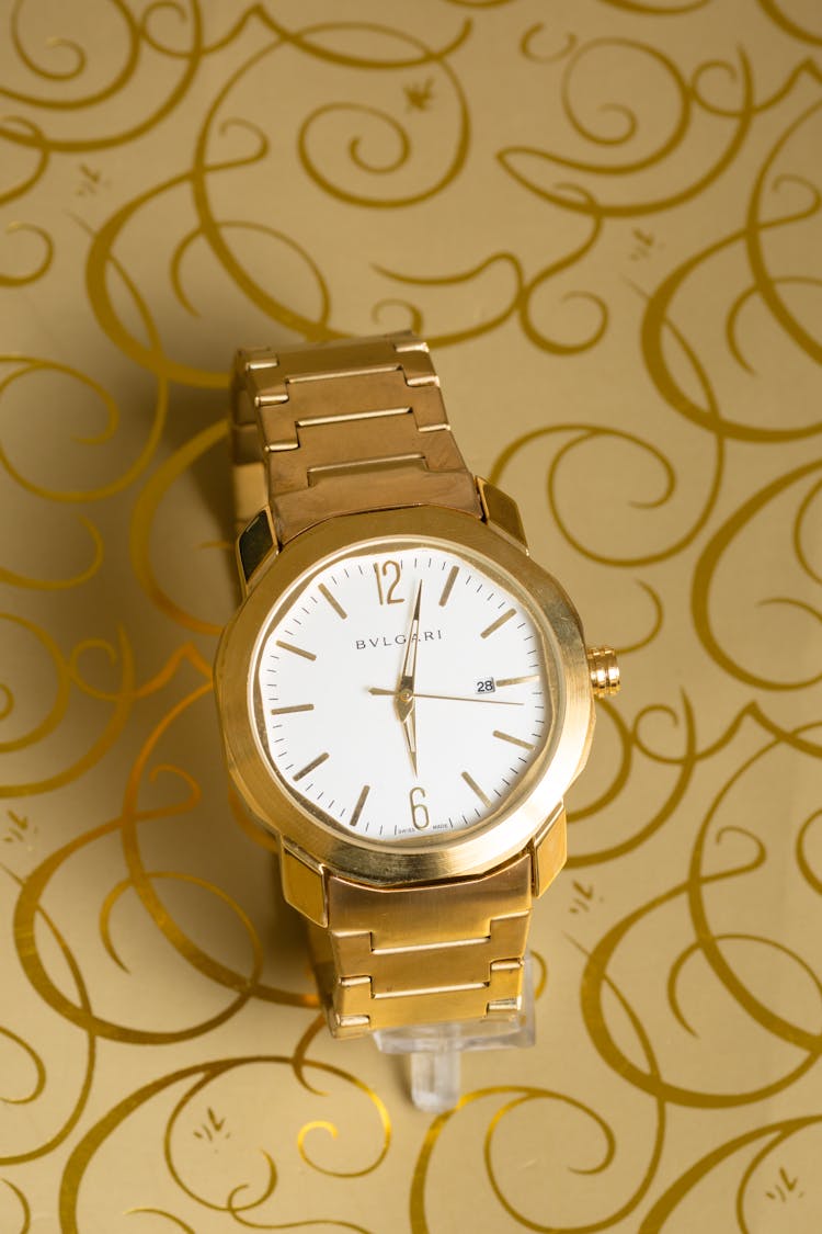 Golden Wristwatch On Patterned Paper