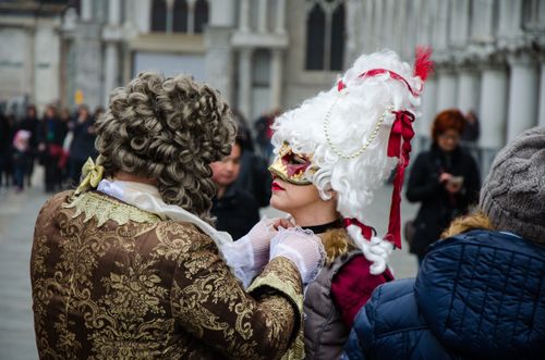 Free Intricate costumes at a lively street festival capturing Venetian carnival spirit. Stock Photo