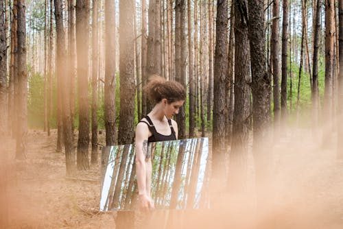 Free A Woman Carrying a Mirror in the Forest  Stock Photo
