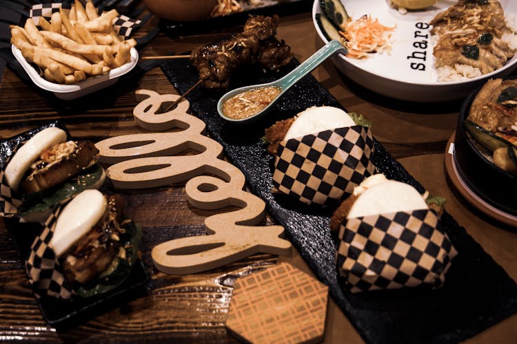 Burgers And Fries On Table In Restaurant 