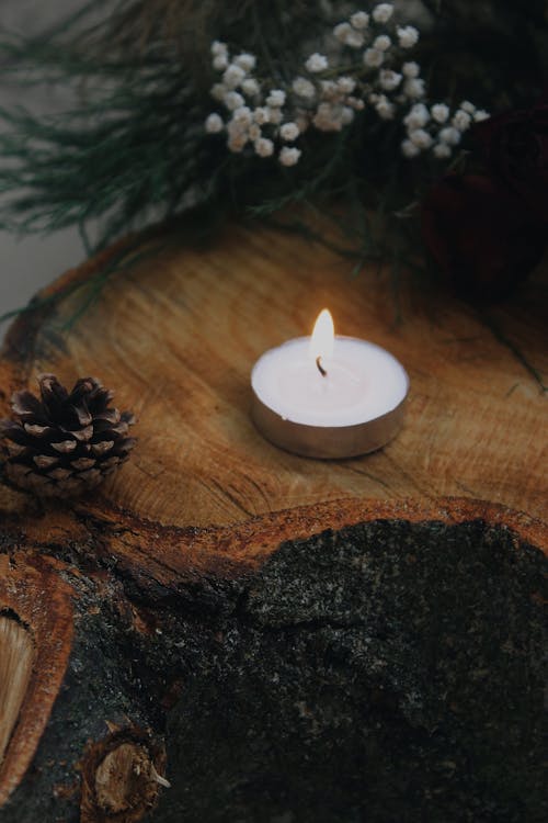 Lighted Tealight on Wooden Surface