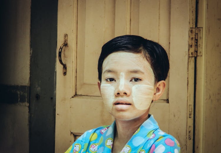 A Child With Thanaka On Her Face