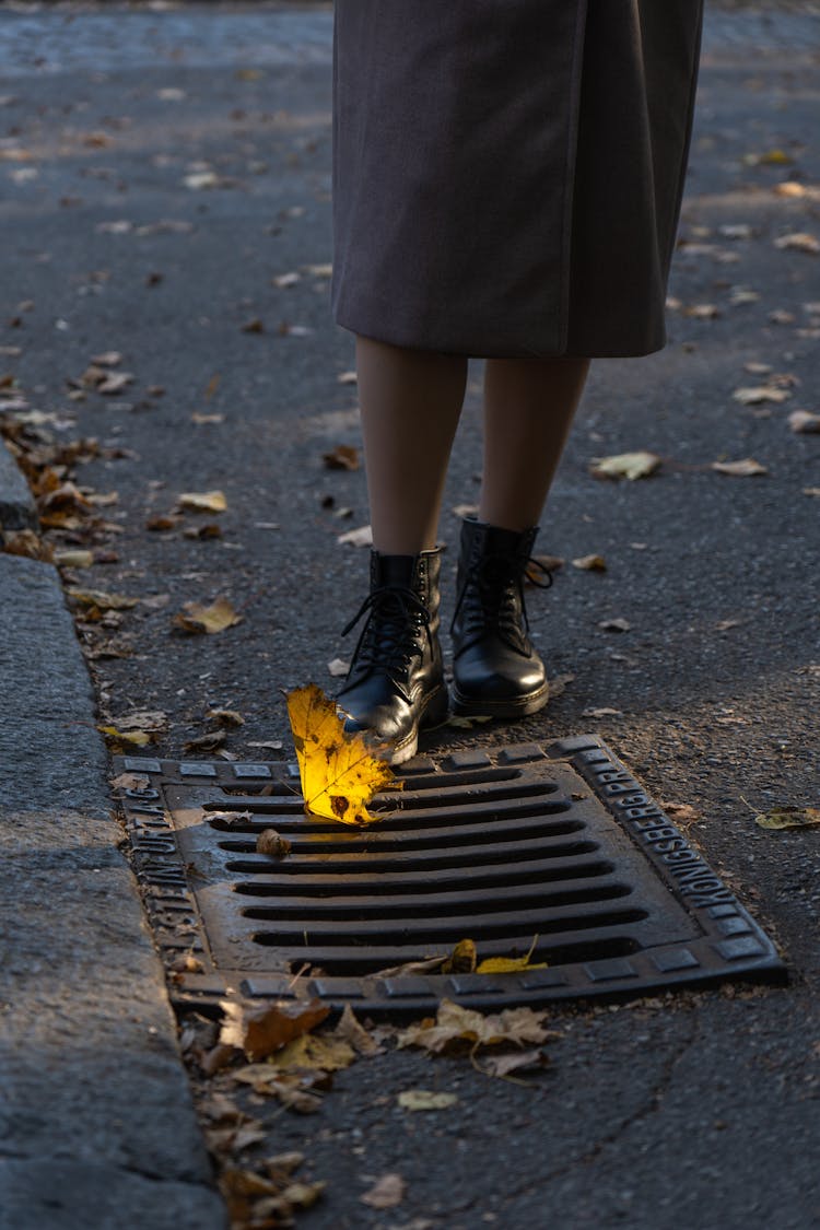 Person Standing Beside A Drainage