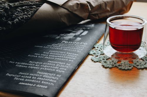 Free A soothing scene of tea and literature, perfect for relaxing moments. Stock Photo