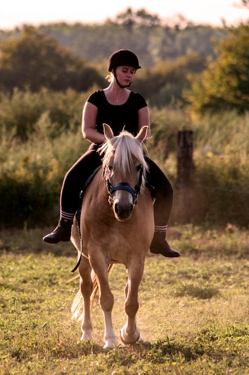 Woman in Black Top Riding a Hose