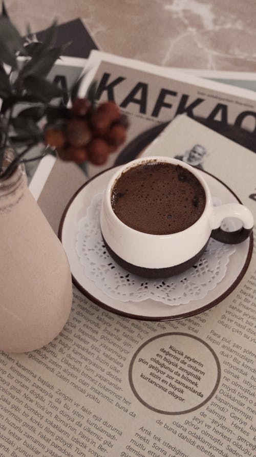 Cup of Hot Chocolate Drink on Top of  Magazine