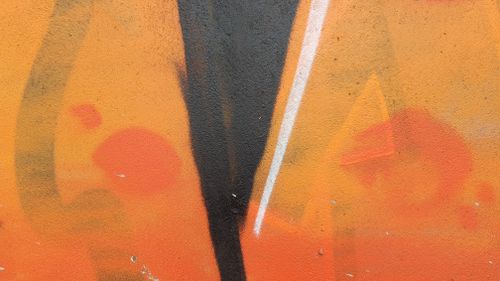 Free Bold abstract graffiti with orange tones on a concrete wall. Stock Photo