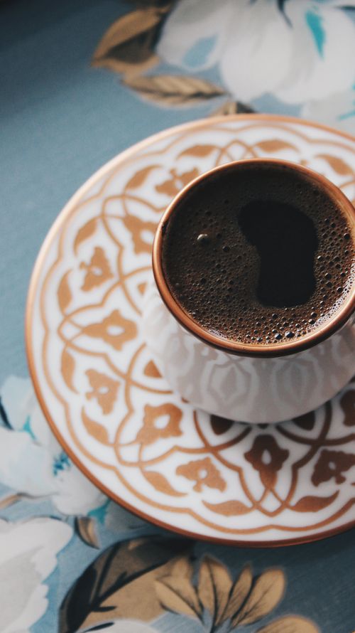 Free Beautiful close-up of a ceramic coffee cup on a patterned saucer, perfect for warm beverage themes. Stock Photo