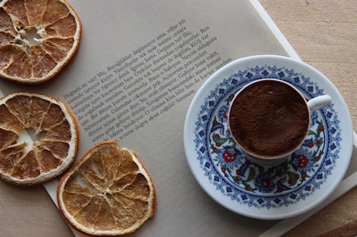 Free Orange Slice and Chocolate Drink on Top of a Book Stock Photo