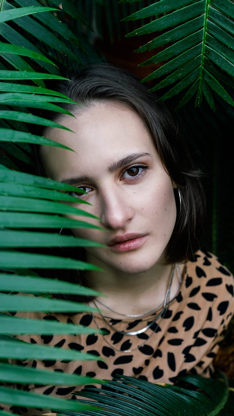 Brunette Woman Between Palm Leaves 