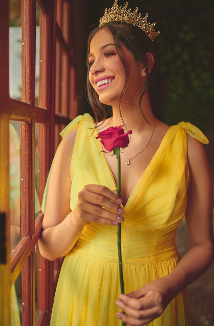 Woman In Yellow Dress Holding A Rose