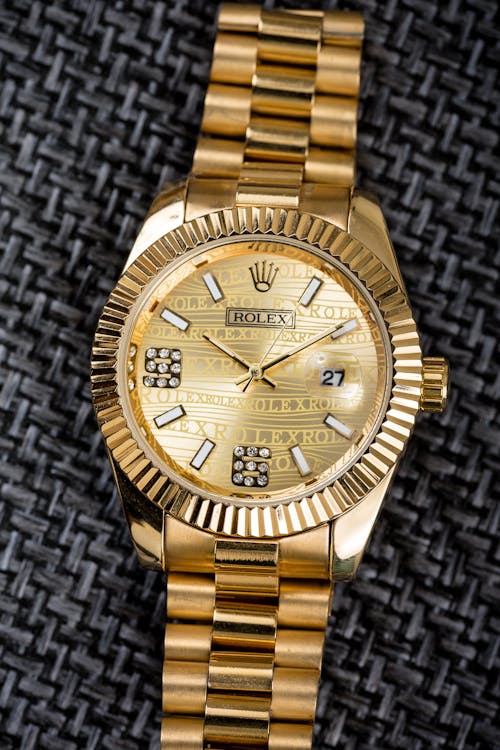 Free Gold Watch on Black Material Stock Photo