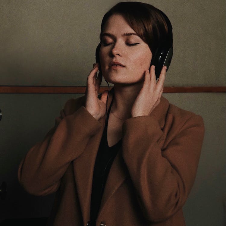Free Woman with Headphones Listening to Music  Stock Photo