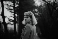 Black and White Portrait of Young Woman Looking over Shoulder 