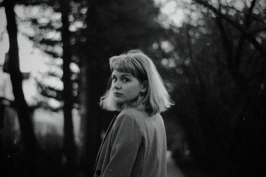 Black and White Portrait of Young Woman Looking over Shoulder 
