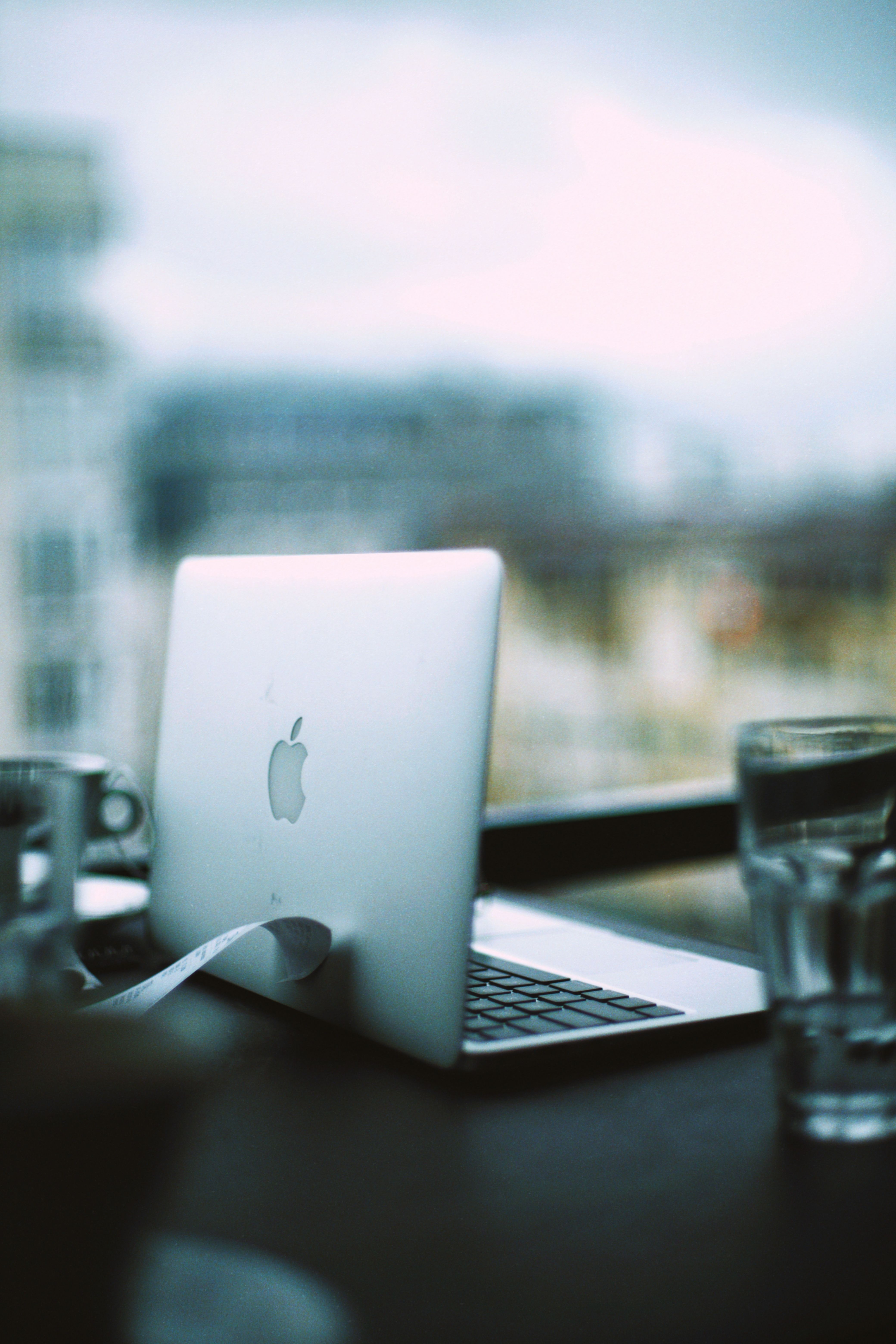 Open Silver MacBook Laying on Desk by Window 