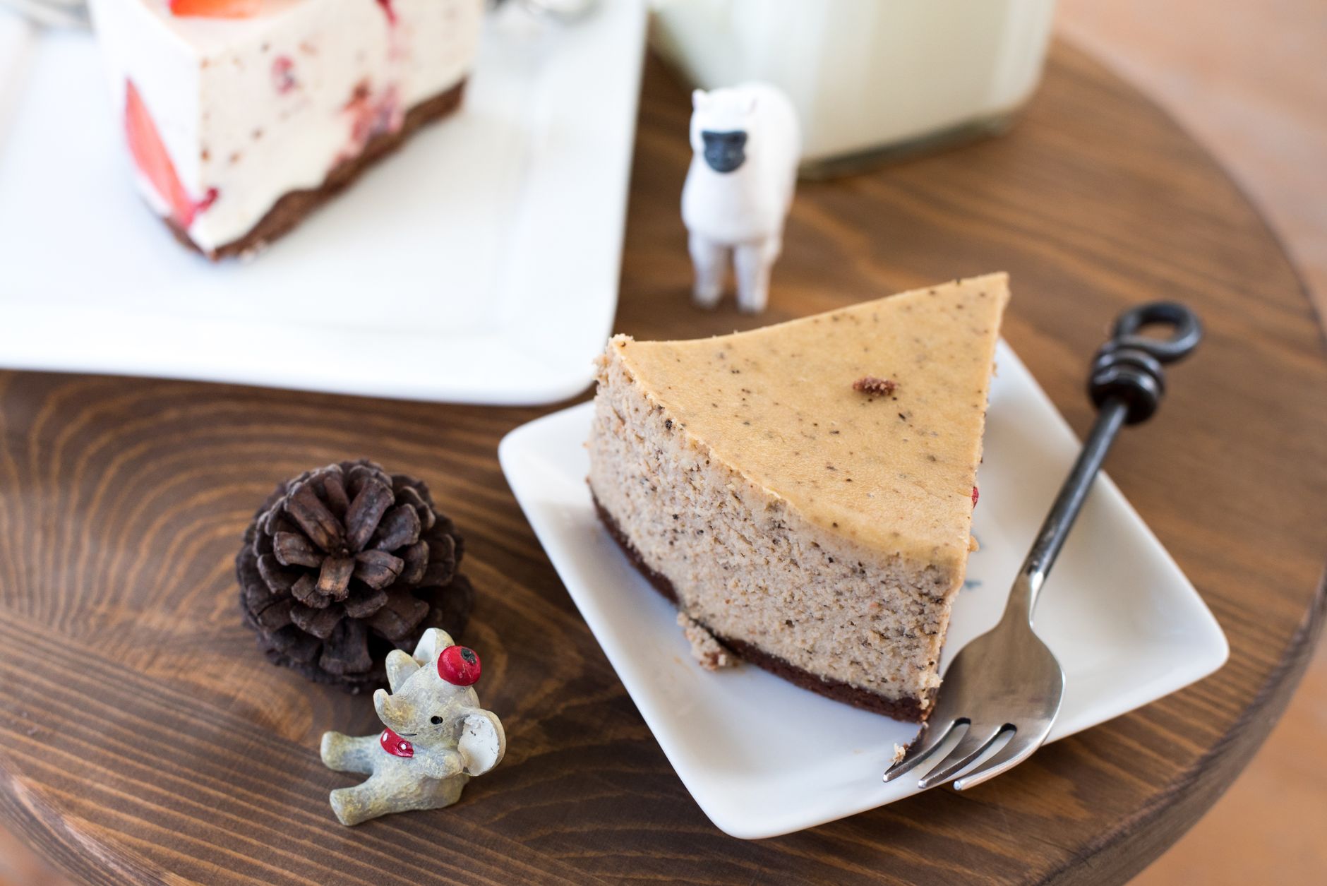 Hand holding a spoonful of creamy tofu chocolate mousse cheesecake