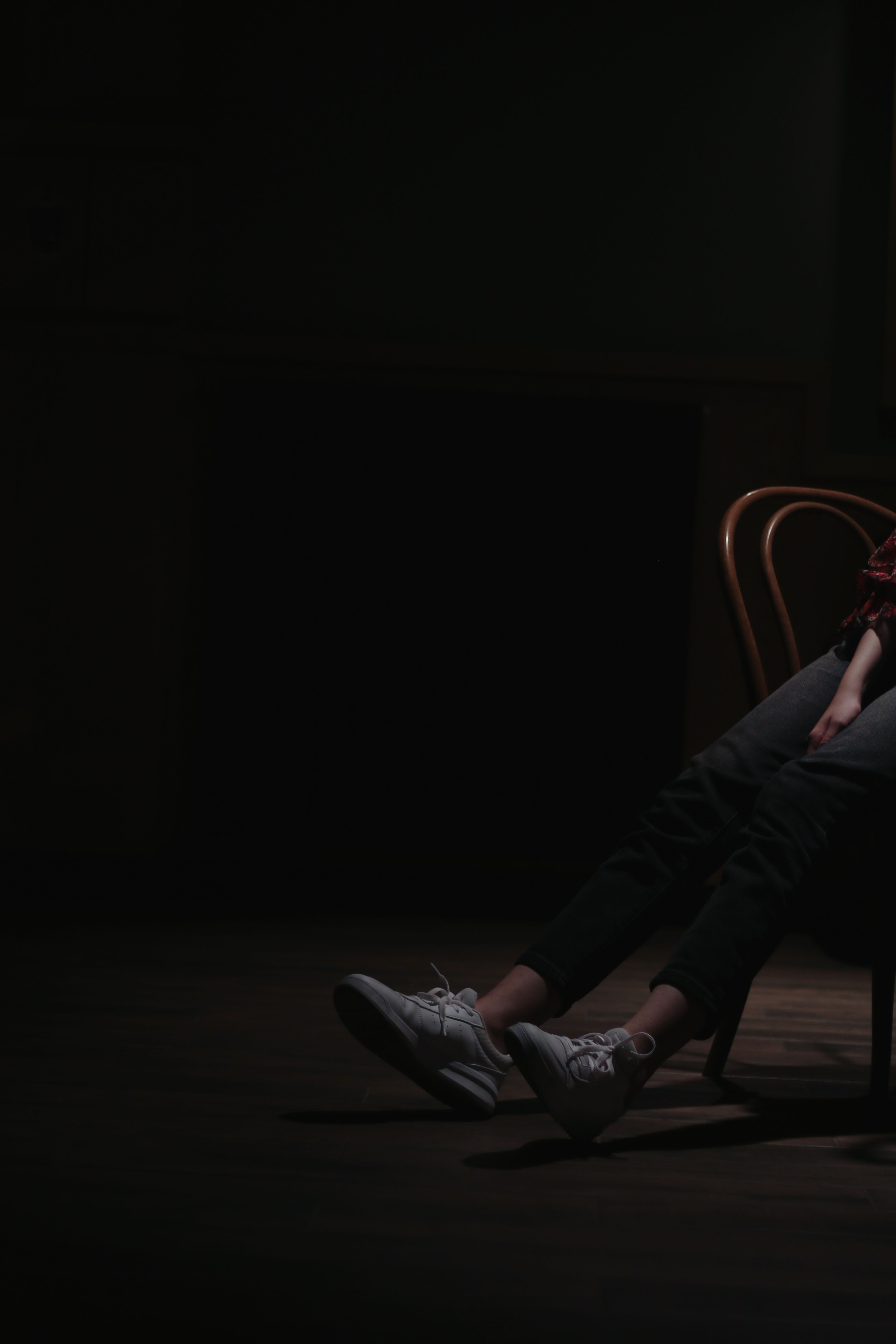 A Person Sitting on a Chair inside a Dark Room · Free Stock Photo