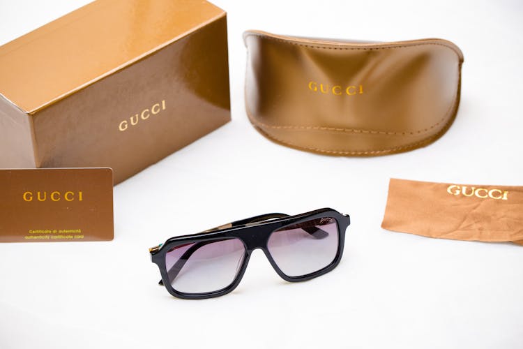 Gucci Sunglasses And A Leather Case 