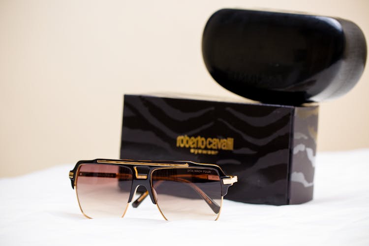 Black And Gold Roberto Cavalli Sunglasses In Close-Up Photography 