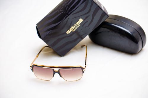 Brown Framed Sunglasses Beside Black Ray Ban Wayfarer Sunglasses