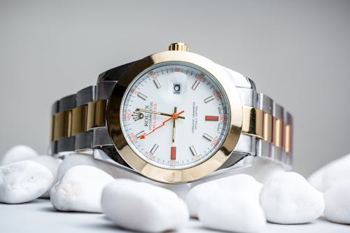 Free Rolex Wristwatch on White Pebbles Stock Photo