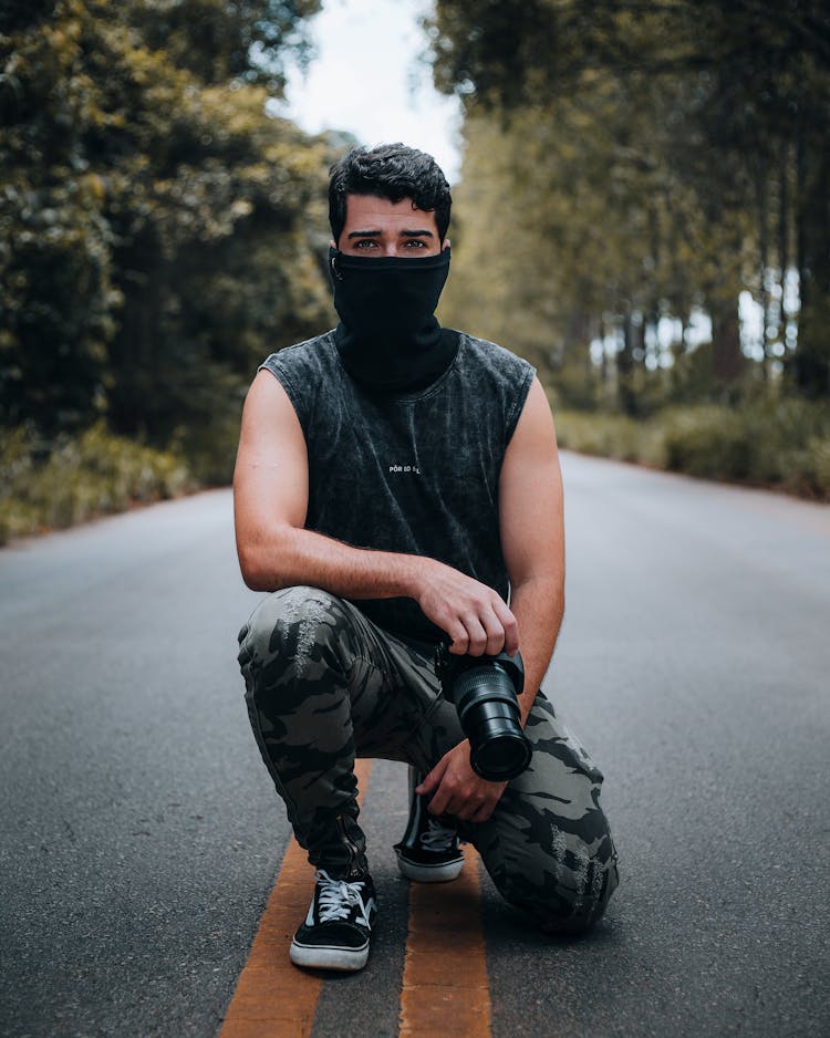 Young Man With A Camera On A Street 