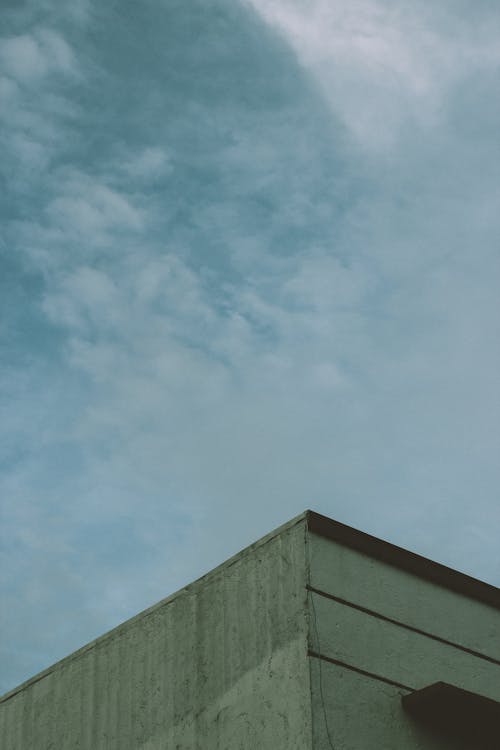 Gray Concrete Building Under the Blue Sky